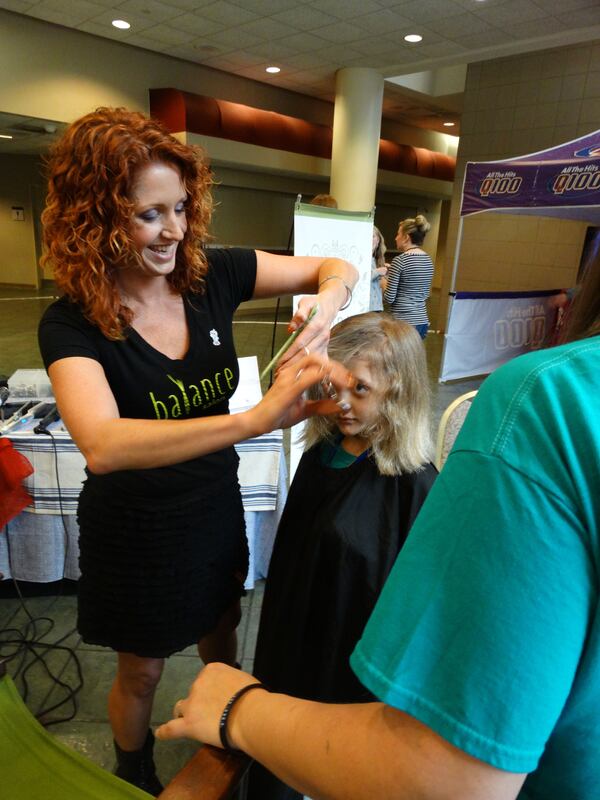 Conor McManus gets his hair trimmed ahead of his trip to Disney World. CREDIT: Rodney Ho/rho@ajc.com