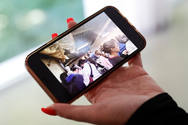 Cheri Levitan shows a photo of teens taking shelter in the bomb shelter at Ben Gurion International Airport in Israel on Tuesday, Oct. 17, 2023. Levitan, the CEO of an Israel-based travel company, was in Tel Aviv when the attacks began and evacuated herself and more than 100 visiting American teenagers. (Natrice Miller/ Natrice.miller@ajc.com)