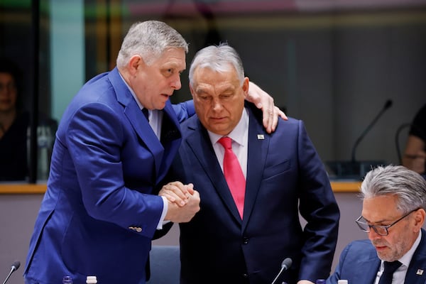 Slovakia's Prime Minister Robert Fico, left, speaks with Hungary's Prime Minister Viktor Orban during a round table meeting at an EU summit in Brussels, Thursday, March 20, 2025. (AP Photo/Omar Havana)