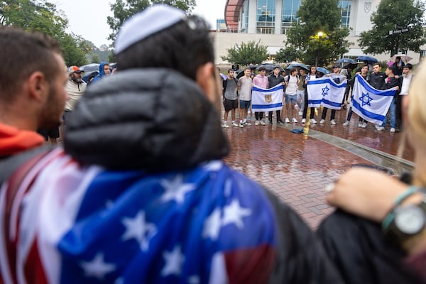 Attendees embrace and sing Jewish songs after a vigil for Israel at Emory University in Atlanta on Wednesday, October 11, 2023. (Arvin Temkar / arvin.temkar@ajc.com)