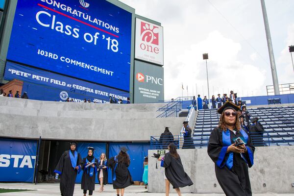 After Parker “Pete” Petit donated $10 million to Georgia State University’s athletic program, the school’s new football field was named for him. In this photo, undergraduate students enter the field for a commencement ceremony in May. REANN HUBER / REANN.HUBER@AJC.COM