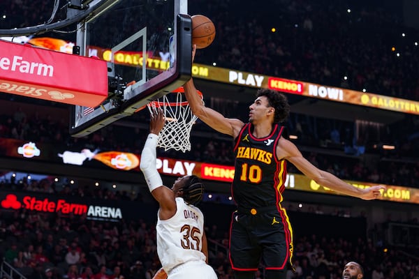 Atlanta Hawks forward Zaccharie Risacher (10) blocks a shot by Cleveland Cavaliers forward Isaac Okoro (35) during the first half of an Emirates NBA Cup basketball game on Friday, Nov. 29, 2024, in Atlanta, at State Farm Arena. (Atlanta Journal-Constitution/Jason Allen)

