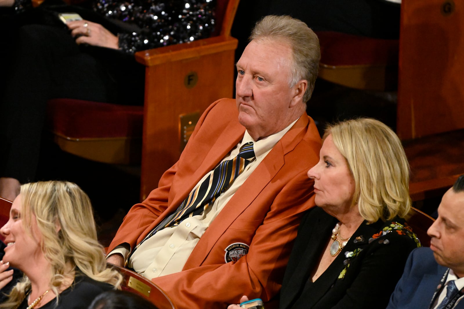 Larry Bird, top, sits in the audience during the Basketball Hall of Fame enshrinement ceremony, Sunday Oct. 13, 2024, in Springfield, Mass. (AP Photo/Jessica Hill)