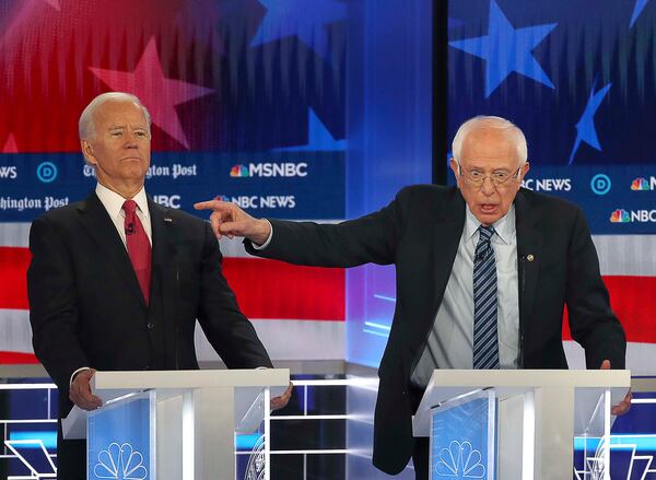  Former Vice President Joe Biden (left) clears the way for Senator Bernie Sanders (center) to make a point, during the MSNBC/The Washington Post Democratic Presidential debate inside the Oprah Winfrey Soundstage at Tyler Perry Studios last November.  Biden and Sanders are the last two major candidates remaining in the race for the Democratic Party nomination. (Alyssa Pointer/Atlanta Journal Constitution)