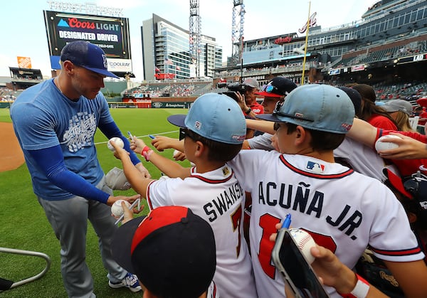 Braves first baseman Freddie Freeman signs autographs for fans during batting practice.    “Curtis Compton / Curtis.Compton@ajc.com”