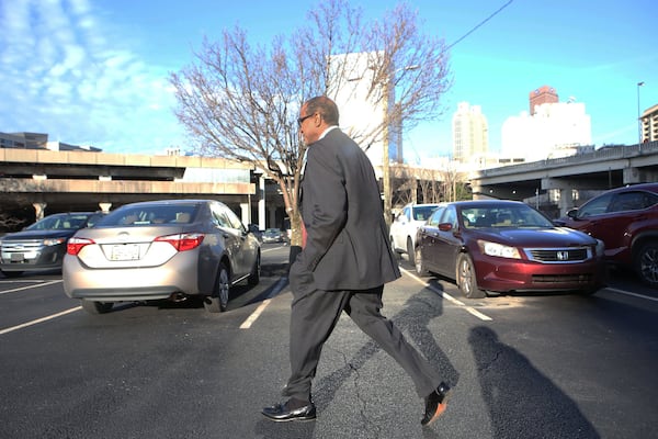 Elvin “E.R” Mitchell Jr. returns to his car after pleading guilty in the Atlanta City Hall bribery investigation on Wednesday, Jan. 25, 2017. (HENRY TAYLOR / HENRY.TAYLOR@AJC.COM)