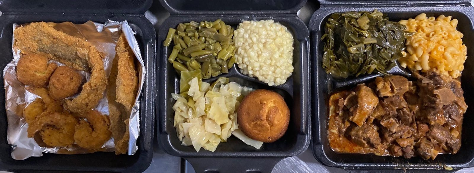 Who’s Got Soul Southern Cafe takeout includes a seafood platter with catfish, whiting, shrimp and hushpuppies; a vegetable plate with green beans, corn, cabbage and a corn muffin; and oxtails over rice with macaroni and cheese and collards. 
Wendell Brock for The Atlanta Journal-Constitution