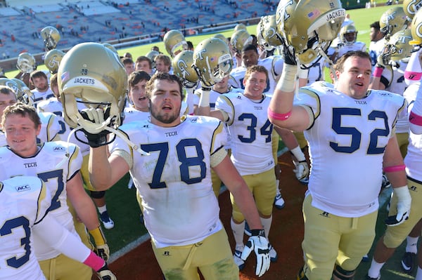 Georgia Tech Yellow Jackets players including offensive linesman Trey Braun (78) and running back Matt Connors (34) and Georgia Tech Yellow Jackets offensive linesman Will Jackson (52) celebrate after the game. The Yellow Jackets defeated the Virginia Cavaliers 35-25 at Scott Stadium. Mandatory Credit: Bob Donnan-USA TODAY Sports