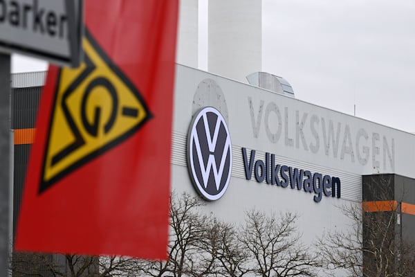 An IG Metall trade union flag flies at the gate of a Volkswagen plant on the first day of a nationwide Volkswagen workers' strike, in Zwickau, Germany, Monday, Dec. 2, 2024. (Hendrik Schmidt/dpa via AP)