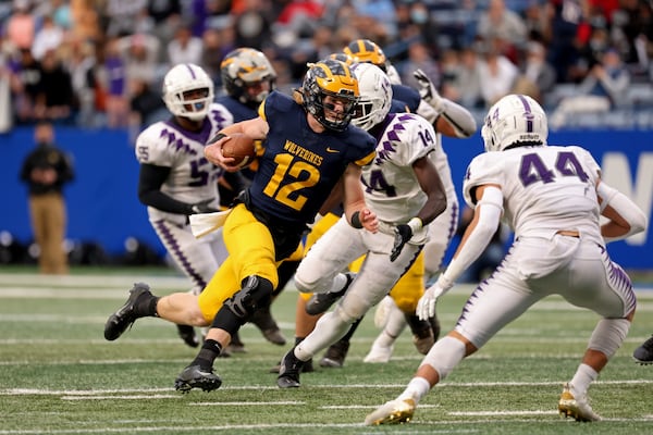 Prince Avenue Christian quarterback Brock Vandagriff (12) runs for a first down in the first half of the Class 1A Private championship against Trinity Christian Dec. 28, 2020, at Center Parc Stadium in Atlanta. (Jason Getz/For the AJC)