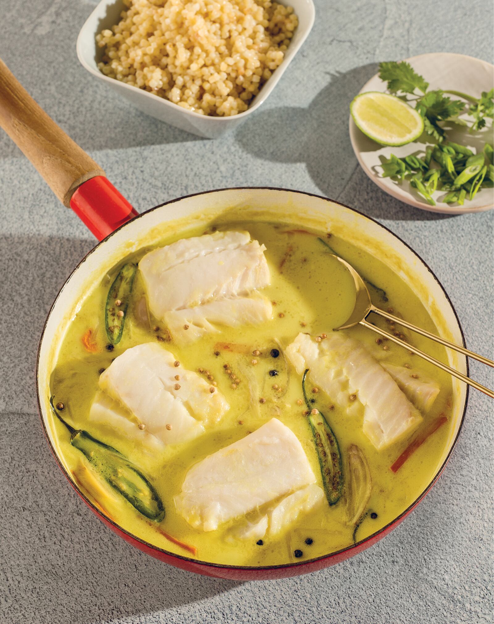 Eating hot foods to cool off comes into play with Coconut Milk, Turmeric, Ginger and Black Pepper-Poached Cod With Israeli Couscous from Vanessa Seder's "Eat Cool: Good Food for Hot Days" cookbook. (Courtesy of Rizzoli USA)