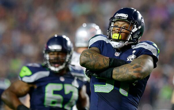 Seattle Seahawks outside linebacker Bruce Irvin (51) celebrates after sacking New England Patriots quarterback Tom Brady during the second half of NFL Super Bowl XLIX football game Sunday, Feb. 1, 2015, in Glendale, Ariz. (AP Photo/Michael Conroy)