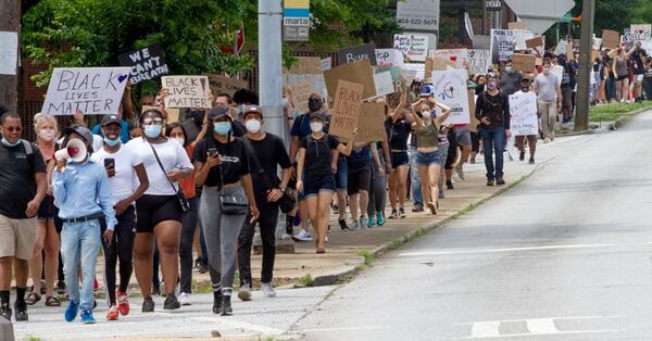 Protesters march in downtown Atlanta on Saturday afternoon during the ninth consecutive day of demonstrations. 