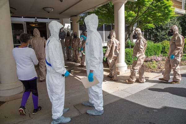 The 265th Infectious Control GA Army National Guard enters the Canterbury Court, a senior living facility in Buckhead, to disinfect the building on Friday, April 10, 2020. STEVE SCHAEFER / Special to the AJC