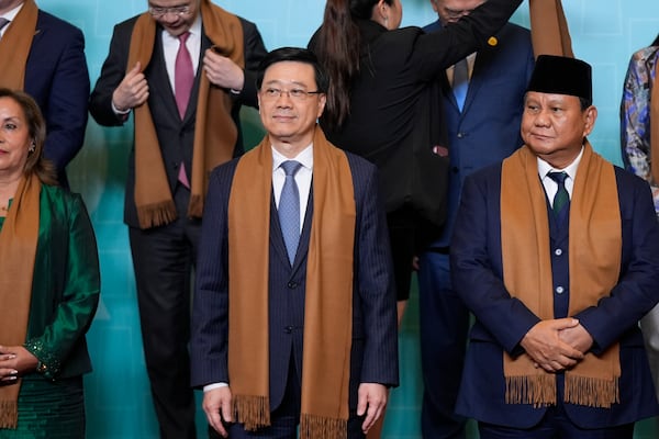 From left, Peru's President Dina Boluarte, Hong Kong's Chief Executive John Lee, Indonesia's President Prabowo Subianto, and other APEC leaders gather for a family photograph at the APEC Summit in Lima, Peru on Saturday, Nov. 16, 2024. (AP Photo/Manuel Balce Ceneta)