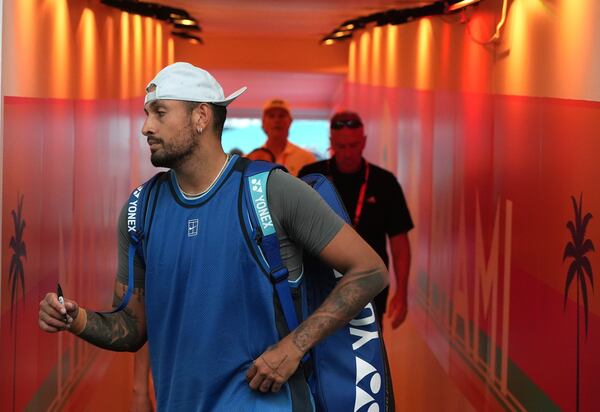 Nick Kyrgios, of Australia, walks from the court to sign autographs after defeating Mackenzie McDonald during the Miami Open tennis tournament, Wednesday, March 19, 2025, in Miami Gardens, Fla. (AP Photo/Lynne Sladky)