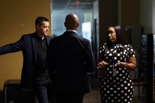 Sgt. Raymond Layton, left, Lt. Ralph Woolfolk, center, and Sgt. April White discuss a case at Atlanta Public Safety Headquarters. Branden Camp/For the Atlanta Journal-Constitution