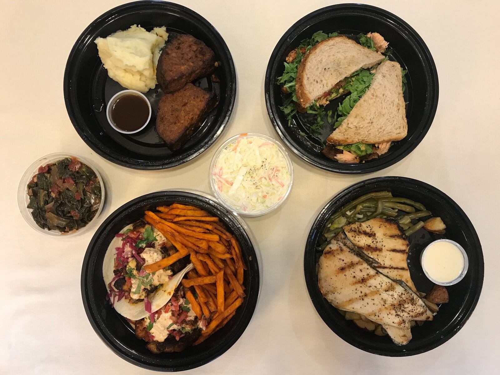 Southern Bistro offers lunch and dinner menus, as well as family meals to go. From top left: three-meat meatloaf, coleslaw, salmon BLT, North Georgia rainbow trout, blackened fish tacos and collard greens. LIGAYA FIGUERAS / LIGAYA.FIGUERAS@AJC.COM