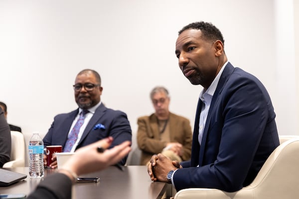 Mayor Andre Dickens (right) speaks with reporters and editors during an editorial board meeting at the Atlanta Journal-Constitution office in Atlanta on Monday, Feb. 10, 2025. (Arvin Temkar / AJC)