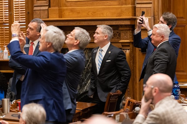 State senators take photos of the voting board following the vote on a bill to rewrite Georgia’s litigation rules to limit lawsuits at the Senate at the Capitol in Atlanta on Friday, February 21, 2025. (Arvin Temkar / AJC)