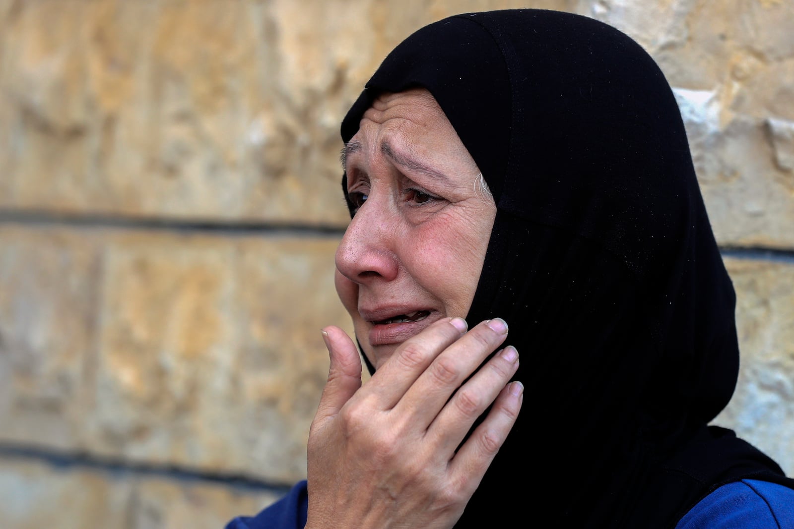 A woman mourns during the funeral procession of people who were killed in an Israeli airstrike on Tuesday night, in Tyre, southern Lebanon, Thursday, Nov. 7, 2024. (AP Photo/Mohammed Zaatari)