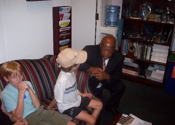 Nine-year-old Michael listens to U.S. Rep. John Lewis, while 11-year-old Fred waits for a Coke during the Torpy family’s 2008 visit to the U.S. Capitol. (Family photo)