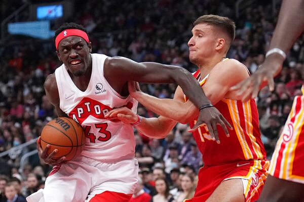 Toronto Raptors forward Pascal Siakam (43) drives to the basket as Atlanta Hawks guard Bogdan Bogdanovic (13) defends during the first half of an NBA basketball game in Toronto on Tuesday, April 5, 2022. (Nathan Denette/The Canadian Press via AP)