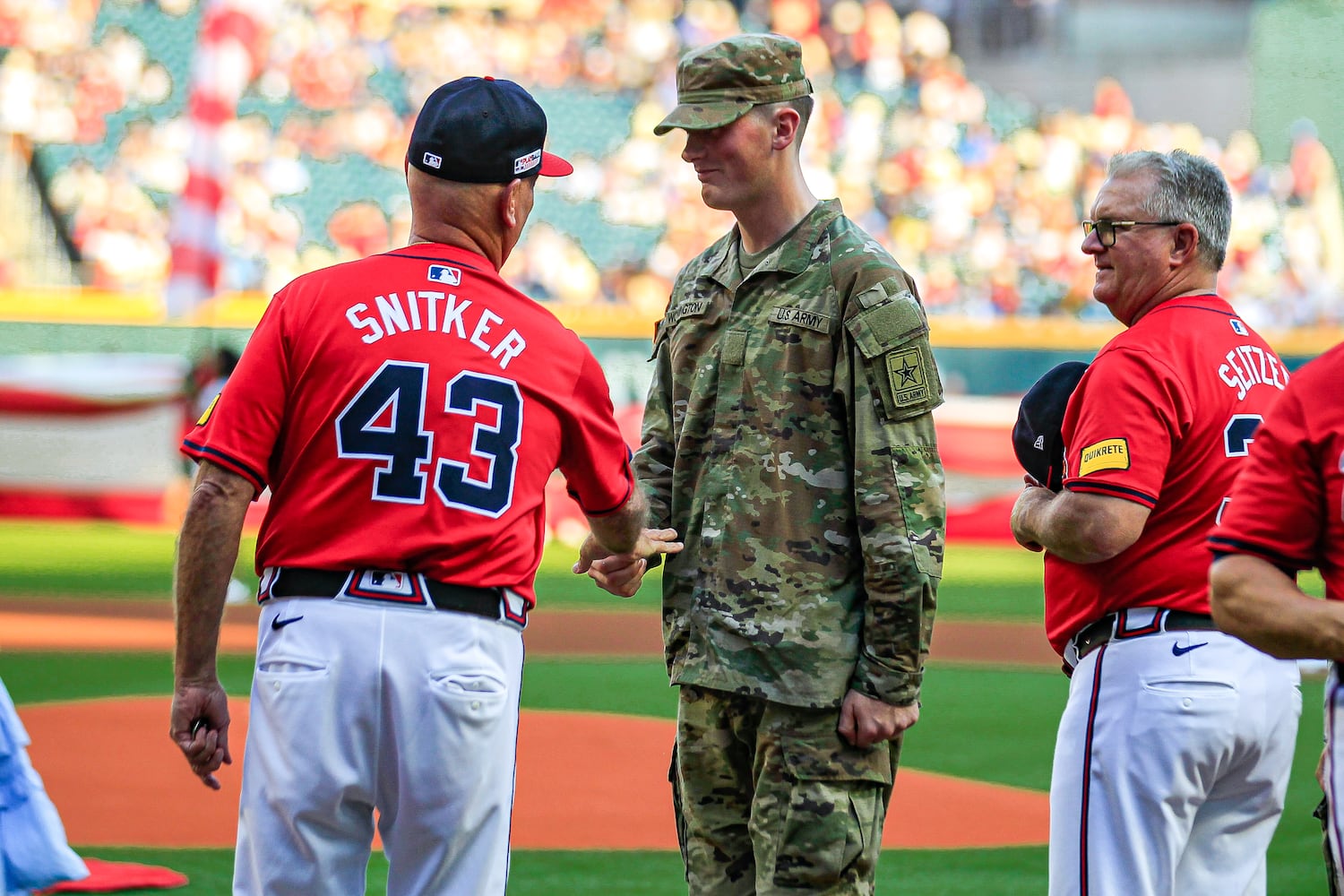 Manager Brain Snitker (left) interacts with an U.S Army solider before the game against the Tampa Bay Rays at Truist Park in Atlanta, Georgia  on Friday, June 14, 2024.   (Ziyu Julian Zhu / AJC)