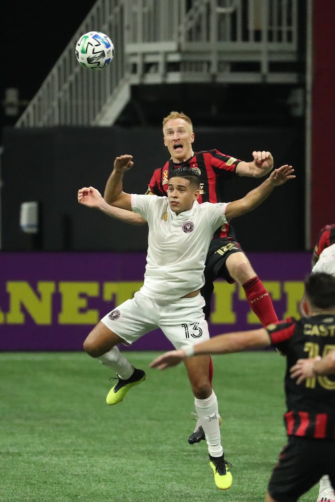 Atlanta United defender Jeff Larentowicz (18) heads the ball against Miami midfielder Vitor Ulloa (13) in the second half at Mercedes-Benz Stadium Saturday, September 19, 2020 in Atlanta. JASON GETZ FOR THE ATLANTA JOURNAL-CONSTITUTION