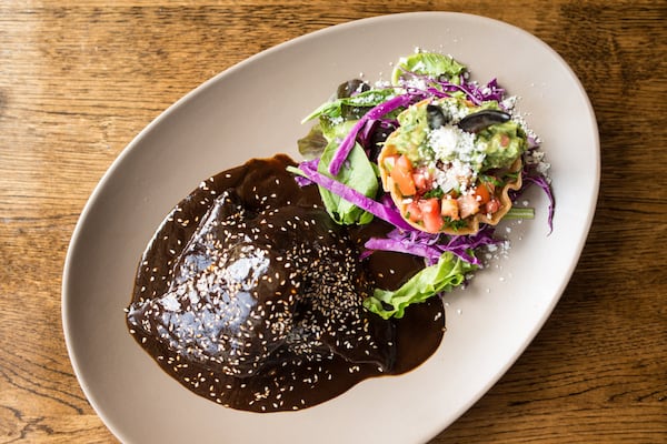 Mole Negro Con Pollo, chicken breast in mole sauce with ground chiles, Mexican spices, rice, and served with tortillas. Photo credit- Mia Yakel.