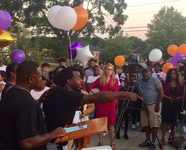 Terrio Reed (pointing) got emotional at the vigil for three teenagers who were shot to death by a man who said the three tried to rob him outside his home. “I’m tired of senseless violence; I’m tired of senseless killing,” he said. Photo by Bill Torpy