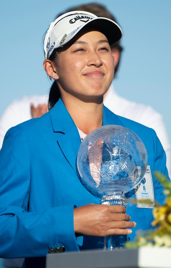 Jeeno Thitikul poses on the 18th green with the LPGA CME Group Tour Championship golf tournament trophy Sunday, Nov. 24, 2024, in Naples, Fla. (AP Photo/Chris Tilley)