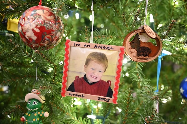 An ornament made with a picture of Grant Martin from 2005 is one of a few on the family's Christmas tree in the living room that honors him. Hyosub Shin/AJC