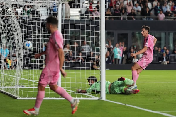 Inter Miami forward Tadeo Allende, right, scores his side's second goal, over Sporting Kansas City goalkeeper John Pulskamp (1), during the first half of a CONCACAF Champions Cup soccer match, Tuesday, Feb. 25, 2025, in Fort Lauderdale, Fla. (AP Photo/Rebecca Blackwell)