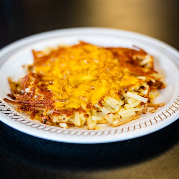 Covered hash browns from Waffle House with melted cheese.