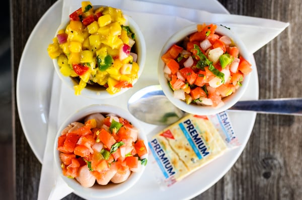 The Ceviche Beginner at Ceviche Taqueria includes a choice of three types of marinated seafood. Clockwise from top: mahi ceviche, tuna ceviche and scallop ceviche. CONTRIBUTED BY HENRI HOLLIS