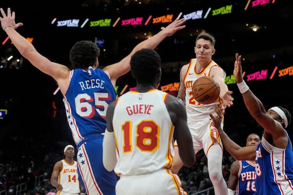 Atlanta Hawks guard Vit Krejci (27) passes to Atlanta Hawks forward Mouhamed Gueye (18) against the Philadelphia 76ers during the first half of an NBA basketball game, Monday, March 10, 2025, in Atlanta. (AP Photo/Mike Stewart)