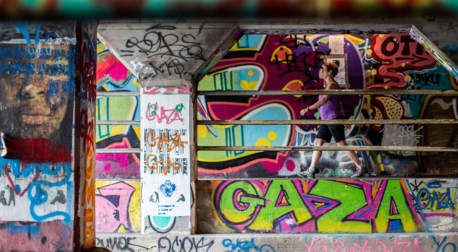 A woman walks through the Krog Street Tunnel, Monday, July 27, 2015, in Atlanta.  BRANDEN CAMP/SPECIAL