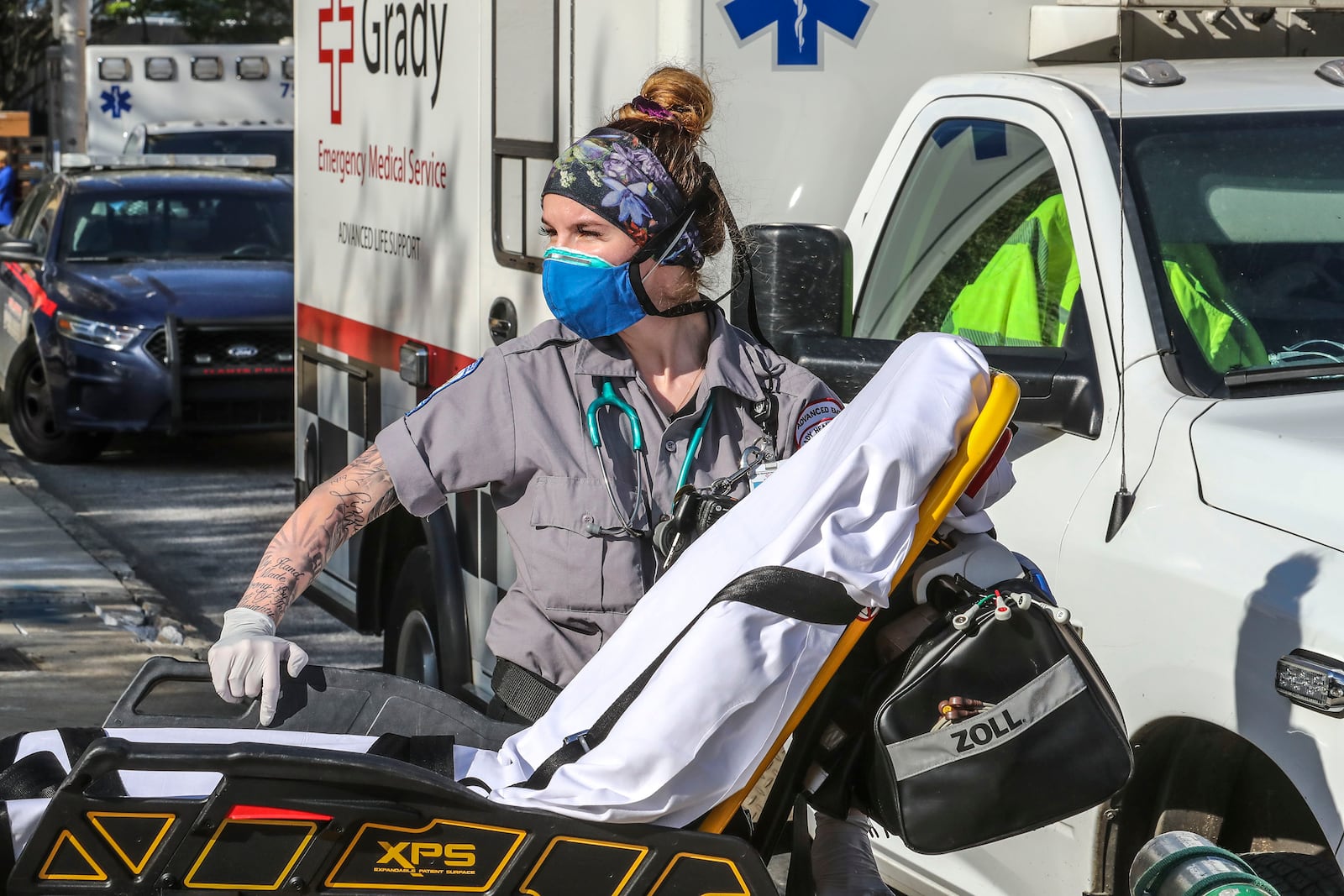 Emma Hovis, a Grady advanced emergency medical technician, prepares for another patient call on Monday, March 30, 2020. First responders at Grady Memorial Hospital are on the front line of the COVID-19 epidemic, taking precautions on each call. JOHN SPINK/JSPINK@AJC.COM