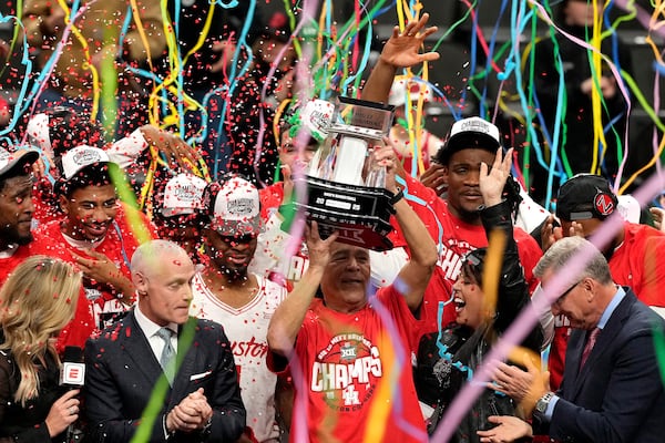 Houston head coach Kelvin Sampson lifts the trophy after winning an NCAA college basketball game against Arizona for the championship in the Big 12 Conference tournament, Saturday, March 15, 2025, in Kansas City, Mo. (AP Photo/Charlie Riedel)