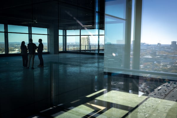 Reporters interview Travis Garland (right), managing director of Portman Holdings, inside the newly completed office tower Spring Quarter in Atlanta on Monday. Arvin Temkar/AJC