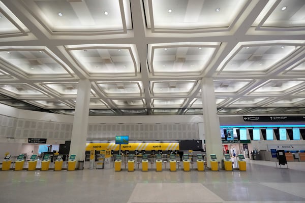 An empty terminal is seen at the closed at George Bush Intercontinental Airport Tuesday, Jan. 21, 2025, in Houston. (AP Photo/David J. Phillip)