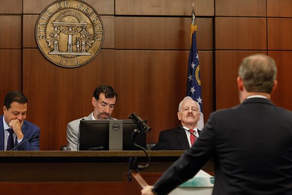 (Left to right) Judicial Qualifications Commission panel Dax Lopez, Judge Robert McBurney and Jack Winter listen to opening statements in the ethics hearing for suspended Georgia Court of Appeals Judge Christian Coomer’s. The three-member panel recommended Coomer be removed from the bench. (Natrice Miller/natrice.miller@ajc.com)  


