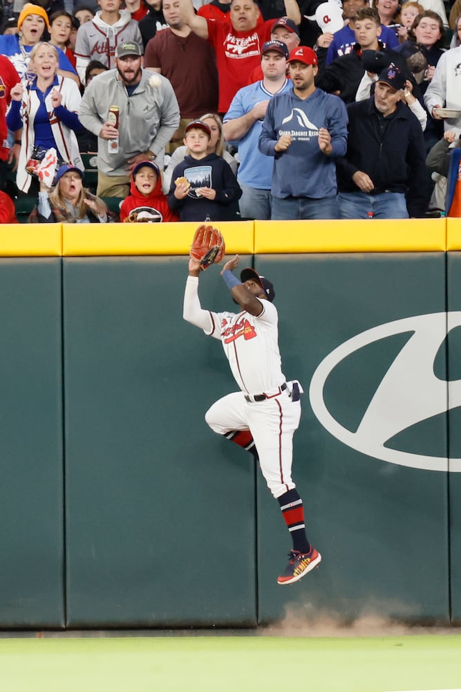 Atlanta Braves center fielder Michael Harris II (23) jumps against the fence to catch the ball during the second inning at Truist Park on Saturday, Oct. 1, 2022. Miguel Martinez / miguel.martinezjimenez@ajc.com 