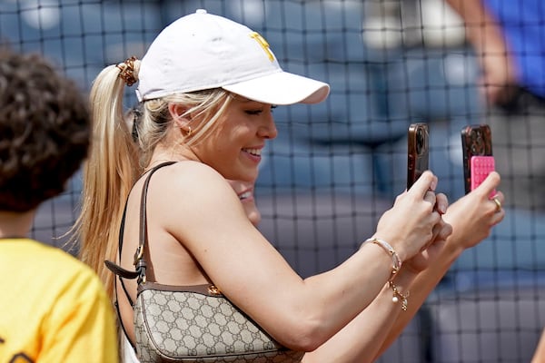 FILE - Pittsburgh Pirates starting pitcher Paul Skenes' girlfriend Livvy Dunne takes a selfie on the field after Skenes pitched in a baseball game against the San Francisco Giants Thursday, May 23, 2024, in Pittsburgh. (AP Photo/Matt Freed, File)