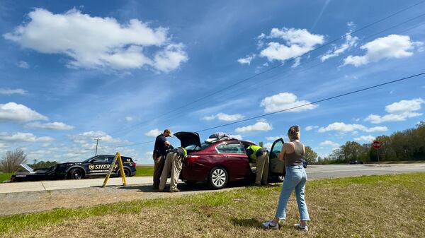 Police along I-16 in Twiggs County searching a car last weekend during the annual St. Patrick's Day license check and sobriety checkpoint they set up at an exit southeast of Macon. (Joe Kovac Jr. / joe.kovac@ajc.com)