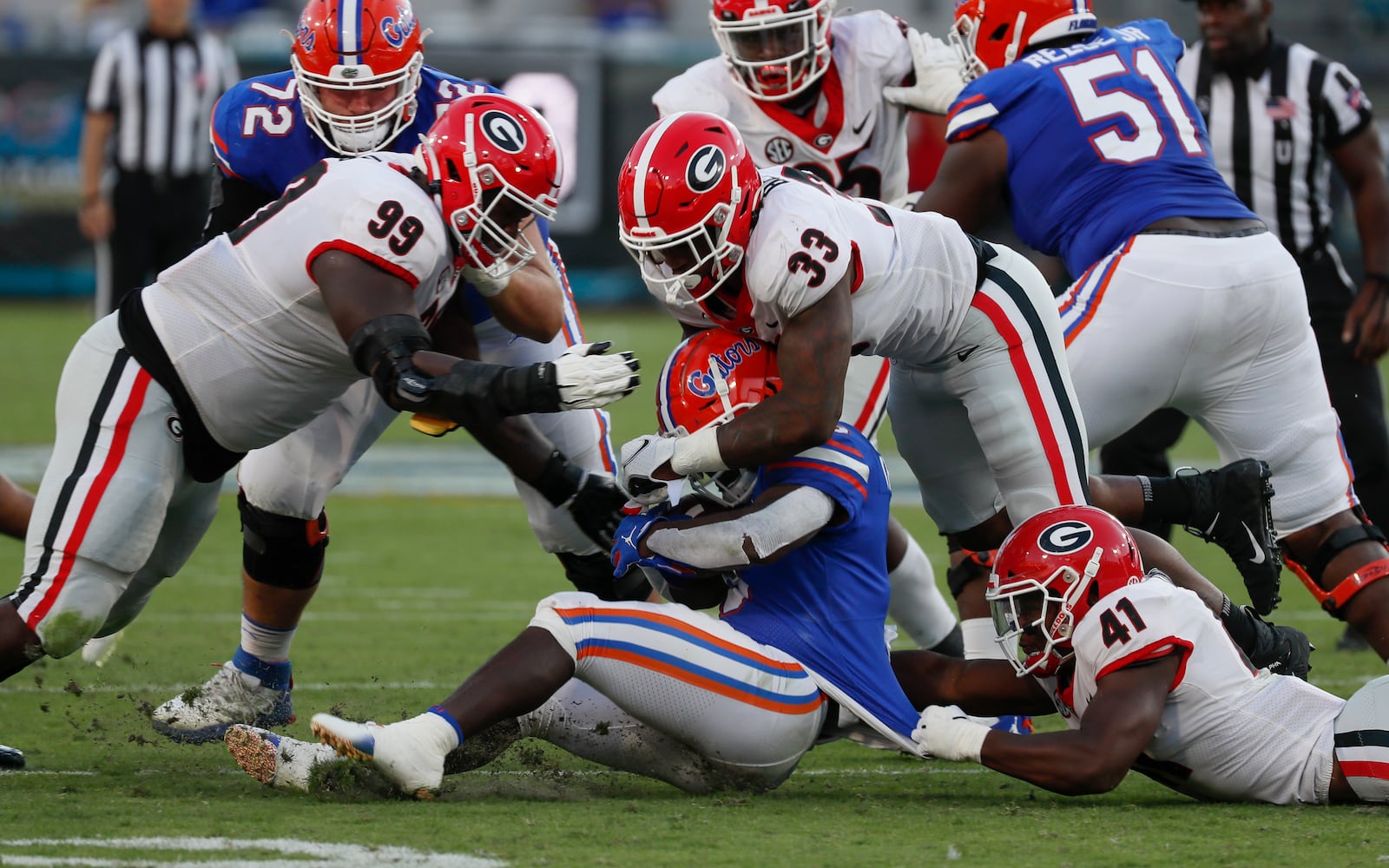 10/30/21 - Jacksonville -   Florida Gators running back Nay'Quan Wright (6) stopped by  Georgia Bulldogs defensive lineman Jordan Davis (99),Georgia Bulldogs linebacker Robert Beal Jr. (33) and Georgia Bulldogs linebacker Channing Tindall (41) during the second half of the annual NCCA  Georgia vs Florida game at TIAA Bank Field in Jacksonville. Georgia won 34-7.  Bob Andres / bandres@ajc.com