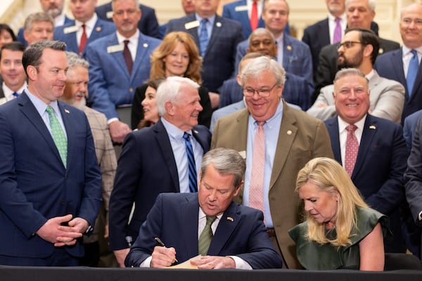 Gov. Brian Kemp signs the budget bill during Crossover Day at the state Capitol in Atlanta on Thursday, March 6, 2025. (Arvin Temkar/AJC)