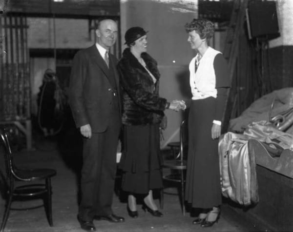 Journalist Mainer Lee Toler, center, a reporter for The Atlanta Constitution, greets Amelia Earhart at Candler Field in 1934. After granting an interview, Earhart flew Toler over Atlanta. (AJC Archive at GSU Library AJCN030-070e)