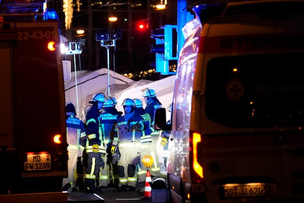 Emergency services work in a cordoned-off area near a Christmas Market, after a car drove into a crowd in Magdeburg, Germany, Friday, Dec. 20, 2024. (AP Photo/Ebrahim Noroozi)